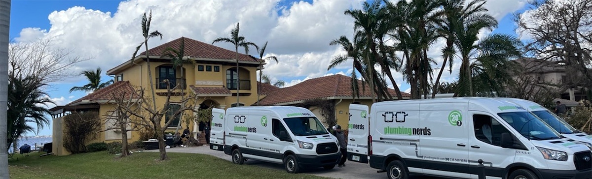 Plumbing Nerds company vans outside house